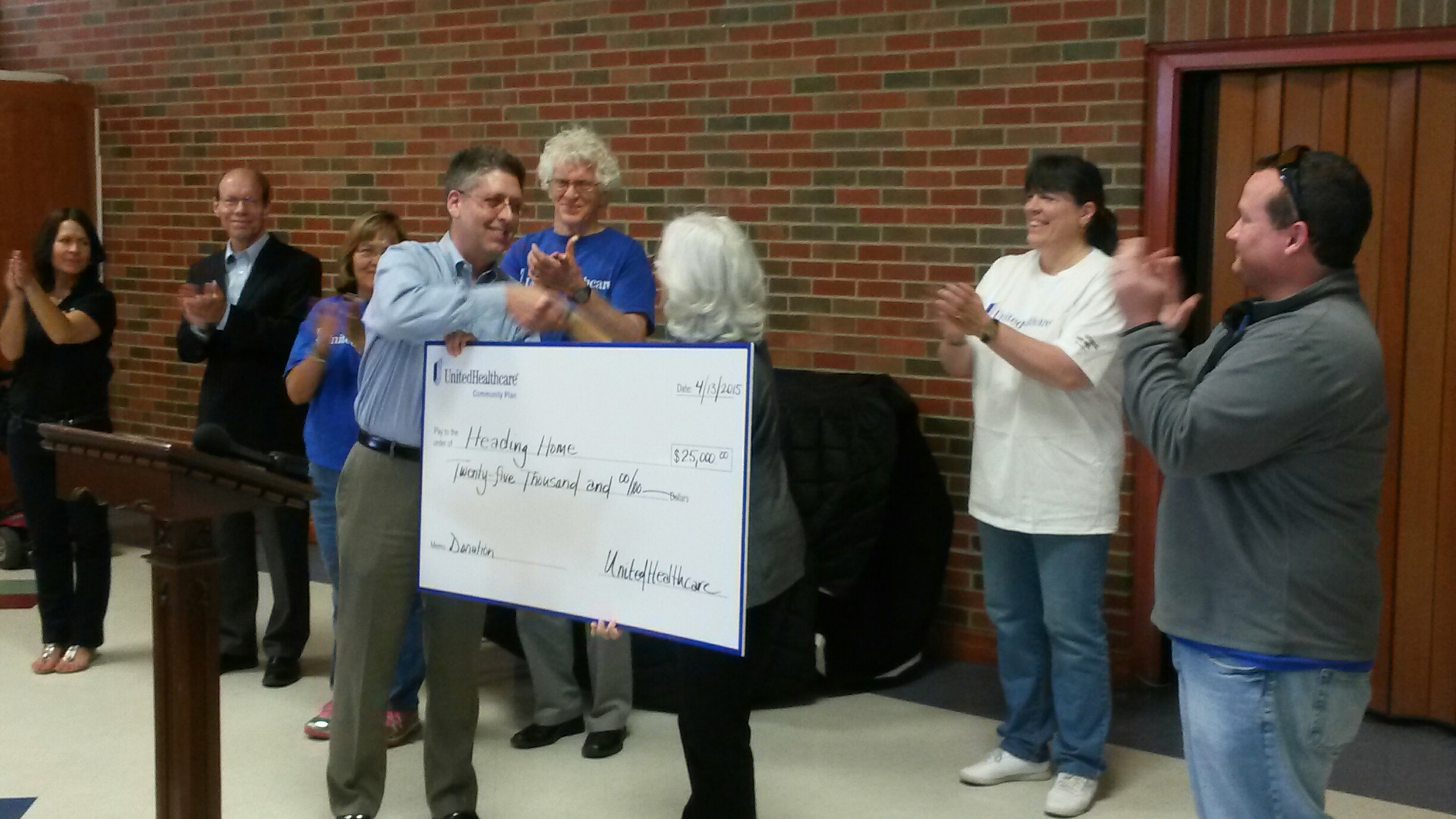 UnitedHealthcare delivers $25,000 grant check to Heading Home CEO Dennis Plummer