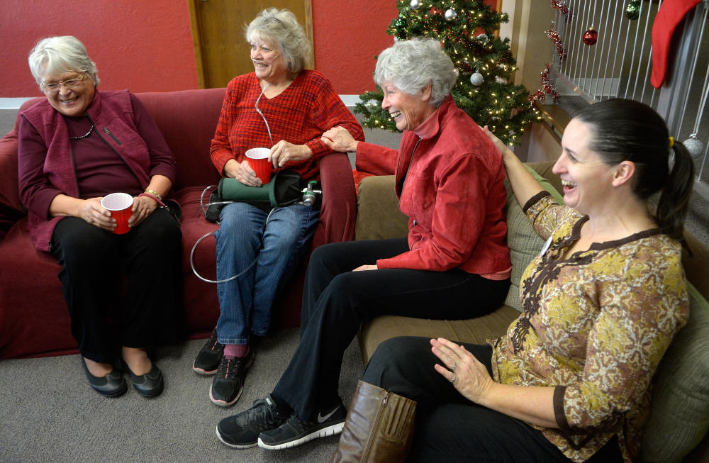gbs121615e/ASEC -- Paula Bogacz-Hetzel, second from left, with her home team Roselie Wendt, Hanniah Morgan and Paula Manning-Lewis, from left, share a laugh at the Heading Home offices on Wednesday, December 16, 2015. (Greg Sorber/Albuquerque Journal)